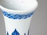 a blue and white vase sitting on a table