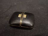 a small black case with a gold zipper on it