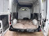 a white van that is parked in the dirt