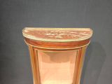 a small wooden table with a marble top on display