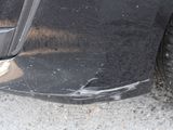 a close up of a car ' s tire on the street