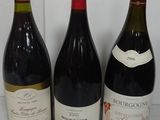 three bottles of wine are lined up on a counter top