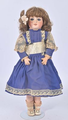 an image of a doll of a little girl in a blue dress
