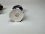 pair of blue and white vases sitting on top of a white table