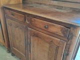 a wooden cabinet that has a door on top of it