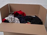 a cardboard box with clothes in it on a table