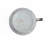 underside view of a white porcelain cup and saucer on a white background