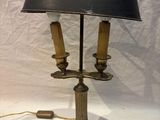 a lamp that is sitting on a table with a black shade