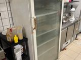 a refrigerator in the middle of a kitchen with a lot of food in it