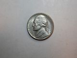 a close up of a coin on a white surface