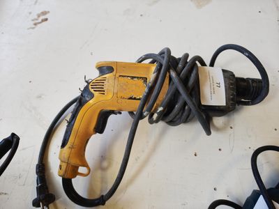 a cord that is connected to a drill on a table