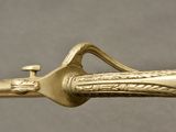a close up of a gold colored handle on a sword