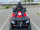 someone is riding on a four - wheeler in a parking lot