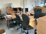 a desk with two computers and two chairs in a room