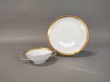 a close up of a cup and saucer on a table