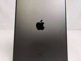 the back of an ipad with a black apple logo on it