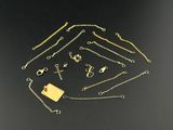 a collection of gold necklaces and bracelets on a black surface