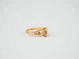 a gold ring with a triangle shaped diamond on top of it