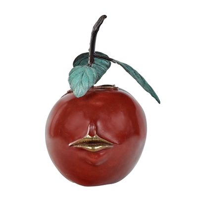 a red apple with a green leaf sticking out of it ' s face