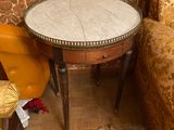 a small table with a marble top in a room