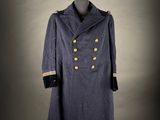 a blue coat with gold buttons on a mannequin stand