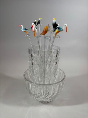 a glass vase with a bunch of birds in it