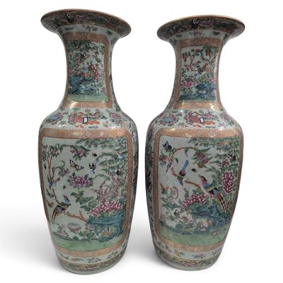 pair of chinese vases with birds and flowers on them on a white background