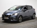 un Nissan Micvan gris garé sur un sol à damier