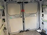 a white van with two doors open in a garage