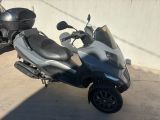 a scooter that is parked on the side of the road