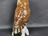 a figurine of an owl sitting on top of a table
