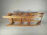 an old fashioned wooden sled with two sleds attached to it
