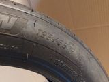the tire of a car is shown on the floor next to a cardboard box