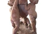 a statue of a man and a woman holding a baby
