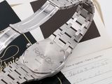 an image of a silver watch sitting on top of a book