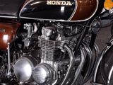 a brown and black motorcycle parked in a garage