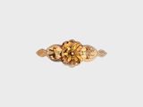 Gros plan sur une bague en or ornée d'une fleur
