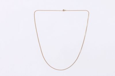 a gold chain necklace with a diamond clasp on a white background