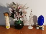 a vase of flowers and a bottle of wine on a table