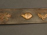 a close up of a metal object with various symbols on it