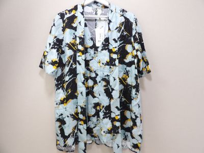 a black and yellow floral shirt hanging on a hanger