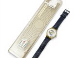 a watch that is sitting next to a box