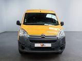yellow citrole van parked in a white room with a black floor