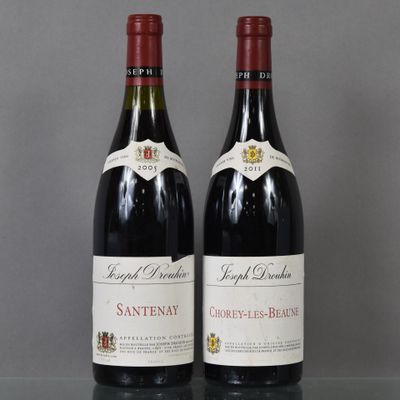 two bottles of wine sitting on top of a table next to each other