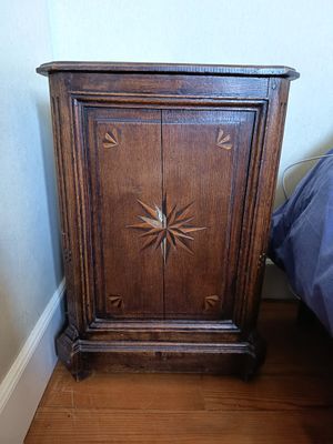 a small wooden cabinet with a star design on it