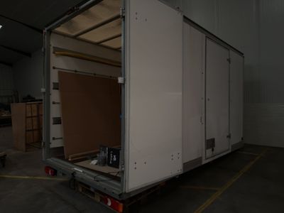 a large white truck that is parked in a garage