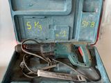 une mallette à outils bleue contenant des outils, posée sur une surface blanche