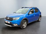 the blue dacia is parked in a room with a black floor