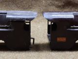 two toy trains that are sitting on the ground