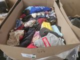 a cardboard box full of clothes that is sitting on a table